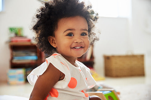 Little girl in playroom smiling