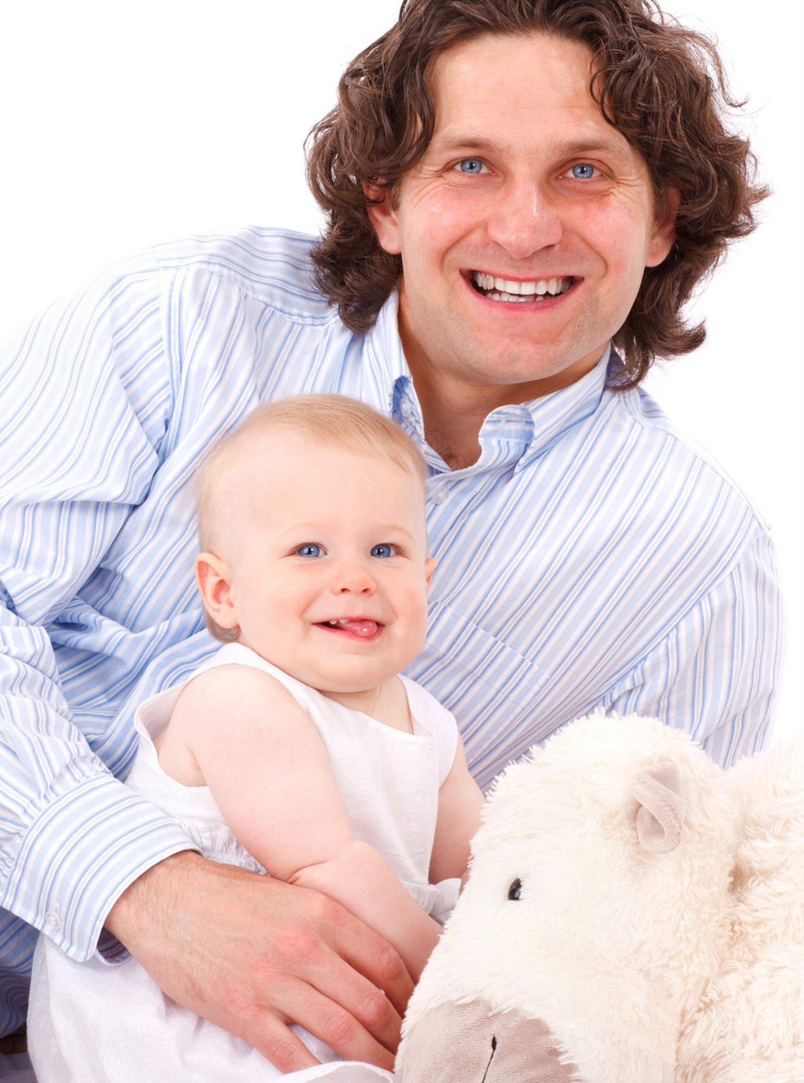 father and baby girl smiling with a teddy bear