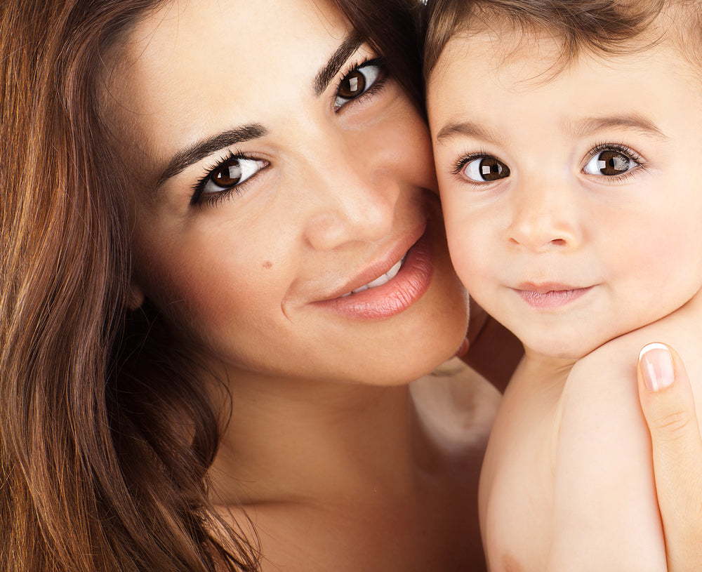Close up of mother and baby with their cheeks pressed together